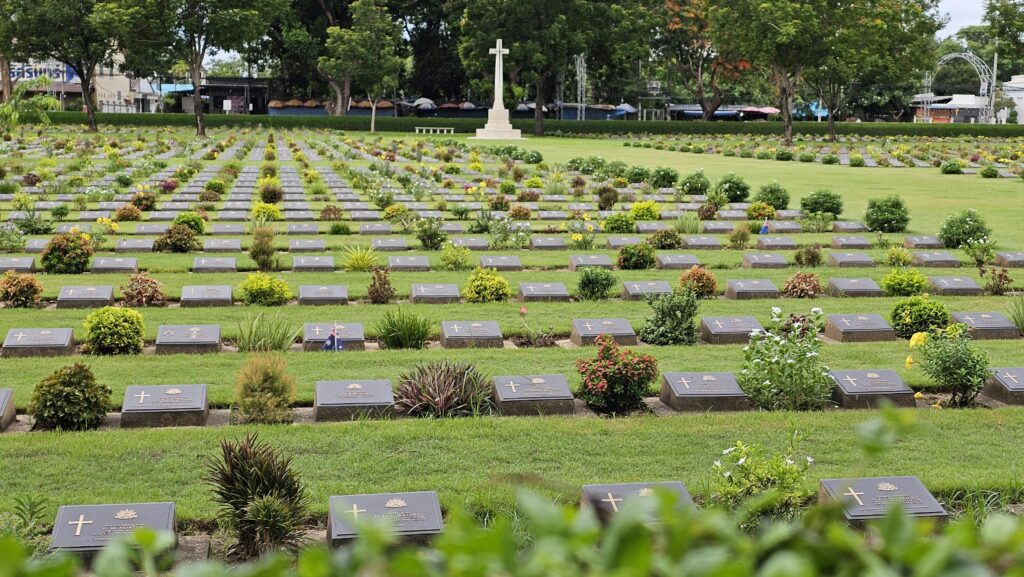 A tranquil view of war graves in Kanchanaburi's beautifully landscaped cemetery.